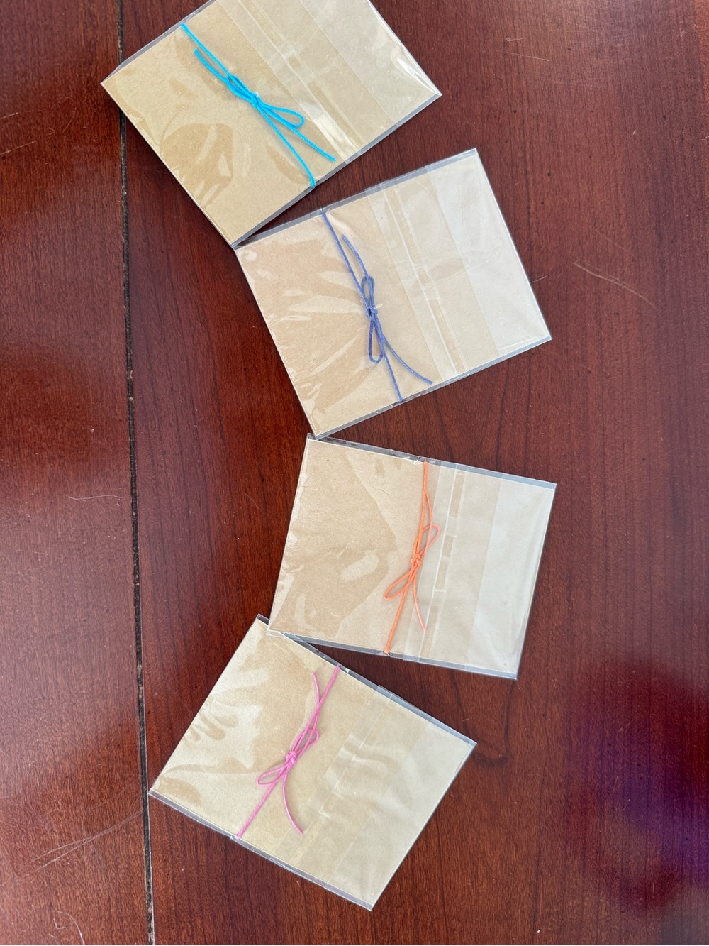 NWT Set of 4 Bracelets with Colored string - NEVER OPENED!